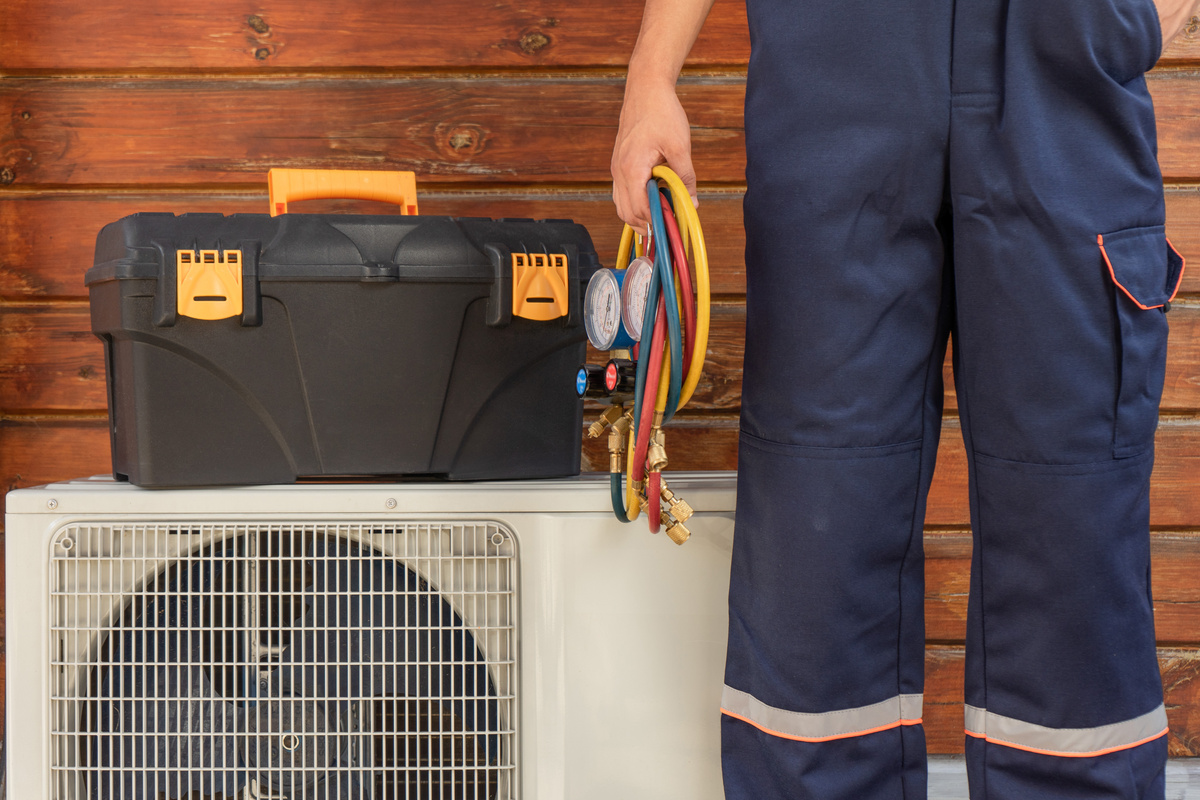 Air conditioner repairman with tools for repair, installation and maintenance of air conditioners